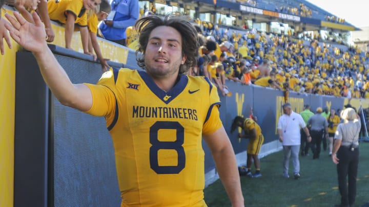Aug 30, 2025; Morgantown, West Virginia, USA; West Virginia Mountaineers quarterback Nicco Marchiol (8) celebrates with fans after defeating the Robert Morris Colonials at Milan Puskar Stadium. Mandatory Credit: Ben Queen-Imagn Images