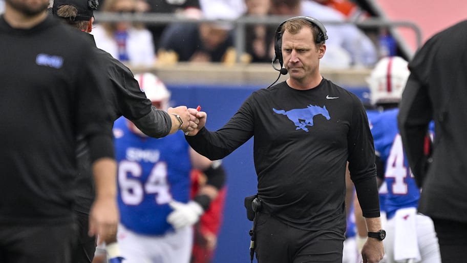 SMU Mustangs head coach Rhett Lashlee celebrates after the Mustangs score a touchdown against the Miami Hurricanes.