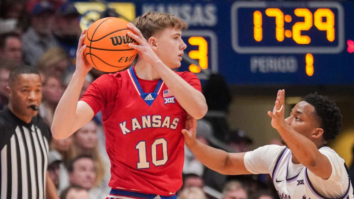 Mar 5, 2024; Lawrence, Kansas, USA; Kansas Jayhawks guard Johnny Furphy (10) looks to pass as Kansas State Wildcats guard Tylor Perry (2) defends during the first half at Allen Fieldhouse. Mandatory Credit: Denny Medley-USA TODAY Sports