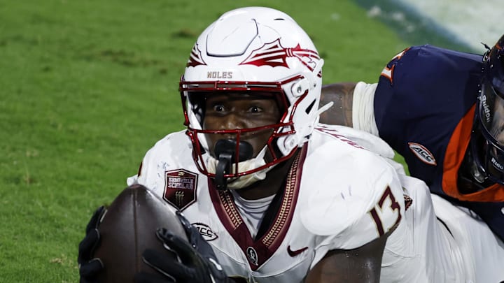 Sep 26, 2025; Charlottesville, Virginia, USA; Florida State Seminoles tight end Randy Pittman Jr. (13) reacts after catching a game tying touchdown pass in the final minute during the fourth quarter in front of Virginia Cavaliers linebacker Kam Robinson (5) during the fourth quarter at Scott Stadium. Mandatory Credit: Geoff Burke-Imagn Images