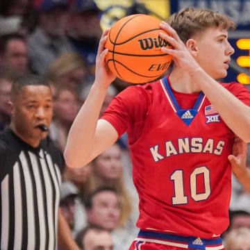 Mar 5, 2024; Lawrence, Kansas, USA; Kansas Jayhawks guard Johnny Furphy (10) looks to pass as Kansas State Wildcats guard Tylor Perry (2) defends during the first half at Allen Fieldhouse. 