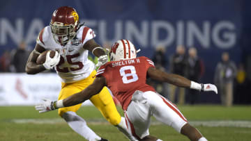 Dec 30, 2015; San Diego, CA, USA; Southern California Trojans running back Ronald Jones II (25) is defended by Wisconsin Badgers cornerback Sojourn Shelton (8) during the 2015 Holiday Bowl at Qualcomm Stadium. Wisconsin defeated USC 23-21. Mandatory Credit: Kirby Lee-USA TODAY Sports