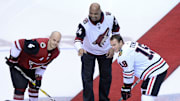 Feb 12, 2018; Glendale, AZ, USA; Hall of Fame NBA player Charles Barkley , Arizona Coyotes defenseman Niklas Hjalmarsson (4) and Chicago Blackhawks center Jonathan Toews (19) poses during a ceremonial puck drop prior to the game at Gila River Arena. Mandatory Credit: Matt Kartozian-Imagn Images