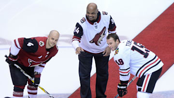 Feb 12, 2018; Glendale, AZ, USA; Hall of Fame NBA player Charles Barkley , Arizona Coyotes defenseman Niklas Hjalmarsson (4) and Chicago Blackhawks center Jonathan Toews (19) poses during a ceremonial puck drop prior to the game at Gila River Arena. Mandatory Credit: Matt Kartozian-Imagn Images