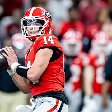 Jan 2, 2025; New Orleans, LA, USA;  Georgia Bulldogs quarterback Gunner Stockton (14) drops back to pass against against the Notre Dame Fighting Irish during the second half at Caesars Superdome. Mandatory Credit: Stephen Lew-Imagn Images