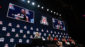 Oct 21, 2025; Kansas City, MO, USA; Arizona head coach Becky Burke (left) and Mickayla Perdue, Sumayah Sugapong and Noelani Cornfield speaks to media during Big 12 Womenís Basketball Media Day at T-Mobile Center. Mandatory Credit: Sophia Scheller-Imagn Images