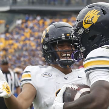 Oct 12, 2024; Pittsburgh, Pennsylvania, USA;  California Golden Bears wide receiver Mikey Matthews (left) congratulates running back Jaivian Thomas (25) on his touchdown against the Pittsburgh Panthers during the first quarter at Acrisure Stadium. Mandatory Credit: Charles LeClaire-Imagn Images