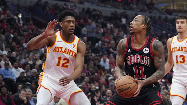 Apr 17, 2024; Chicago, Illinois, USA; Atlanta Hawks forward De'Andre Hunter (12) defends Chicago Bulls forward DeMar DeRozan (11) during the first quarter during a play-in game of the 2024 NBA playoffs at United Center. Mandatory Credit: David Banks-USA TODAY Sports