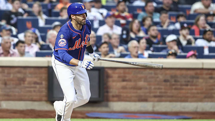 Jun 26, 2024; New York City, New York, USA;  New York Mets designated hitter J.D. Martinez (28) hits an RBI single in the third inning against the New York Yankees at Citi Field.