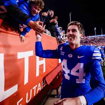 BYU kicker Will Ferrin celebrates with fans after making game-winning kick against Utah