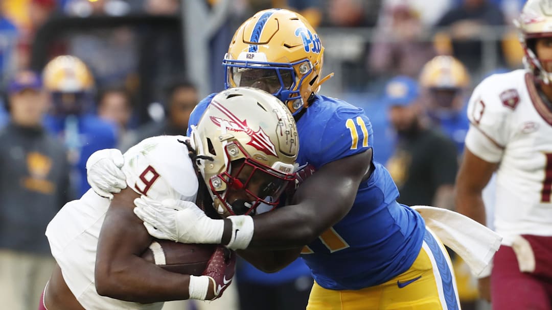 Nov 4, 2023; Pittsburgh, Pennsylvania, USA;  Pittsburgh Panthers linebacker Bangally Kamara (11) tackles Florida State Seminoles running back Lawrance Toafili (9) in the backfield during the second quarter at Acrisure Stadium. Mandatory Credit: Charles LeClaire-Imagn Images