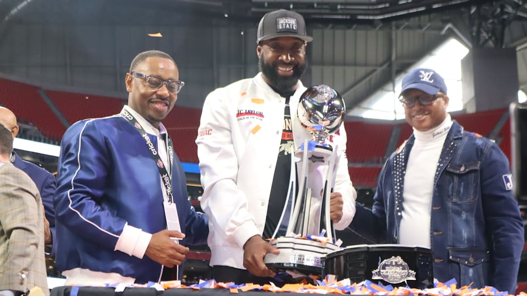 Jackson State's athletic director Ashley Robinson, head coach TC Taylor, and president Marcus L. Thompson are receiving the 2024 Cricket Celebration Bowl Trophy.  December 14, 2024.  Mercedes-Benz Stadium.  Credit: Kyle T. Mosley, HBCU Legends