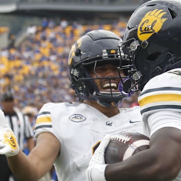 Oct 12, 2024; Pittsburgh, Pennsylvania, USA;  California Golden Bears wide receiver Mikey Matthews (left) congratulates running back Jaivian Thomas (25) on his touchdown against the Pittsburgh Panthers during the first quarter at Acrisure Stadium. Mandatory Credit: Charles LeClaire-Imagn Images