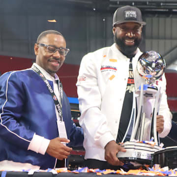 Jackson State's athletic director Ashley Robinson, head coach TC Taylor, and president Marcus L. Thompson are receiving the 2024 Cricket Celebration Bowl Trophy.  December 14, 2024.  Mercedes-Benz Stadium.  Credit: Kyle T. Mosley, HBCU Legends