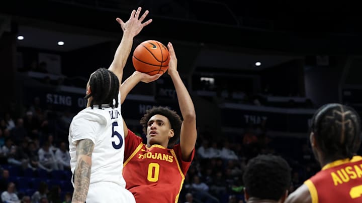 Feb 8, 2026; University Park, Pennsylvania, USA; Southern California Trojans guard Alijah Arenas (0) attempts a three-point shot as Penn State Nittany Lions guard Freddie Dilione V (5) defends during the second half at Bryce Jordan Center. Mandatory Credit: Matthew O'Haren-Imagn Images