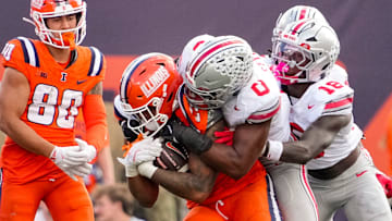 Ohio State Buckeyes linebacker Sonny Styles (0) tackles Illinois Fighting Illini tight end Jordan Anderson (23) during the second half of the NCAA football game at Gies Memorial Stadium in Champaign on Oct. 11, 2025. Ohio State won 34-16.