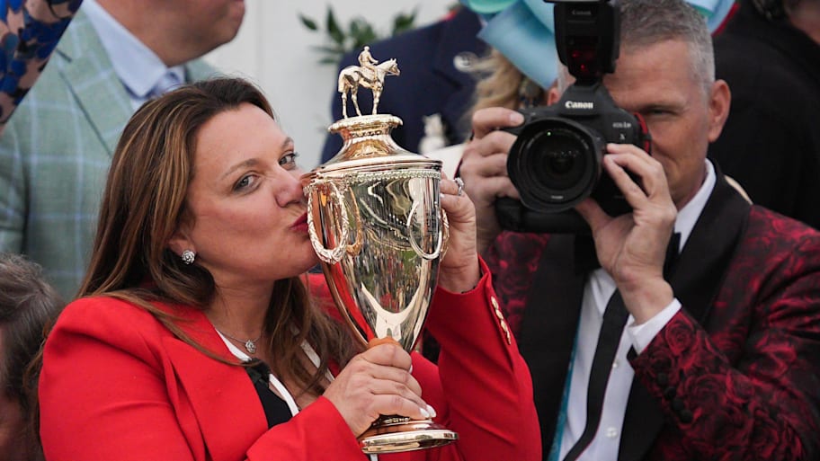 Trainer Cherie DeVaux kisses the trophy after her horse Golden Tempo won the Kentucky Derby.