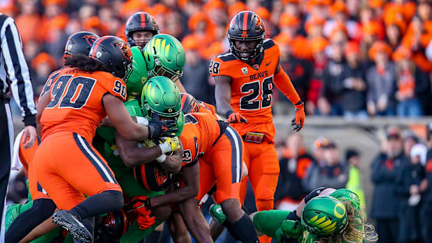 A pack of Oregon State defenders stop Oregon   s Noah Whittington as the No. 9 Oregon Ducks take on the No. 21 Oregon State B