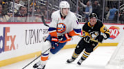 Dec 29, 2024; Pittsburgh, Pennsylvania, USA;  New York Islanders defenseman Noah Dobson (8) moves the puck behind the net ahead of Pittsburgh Penguins center Noel Acciari (55) during the third period at PPG Paints Arena. Mandatory Credit: Charles LeClaire-Imagn Images