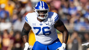 Nov 23, 2024; Tempe, Arizona, USA; Brigham Young Cougars offensive lineman Caleb Etienne (76) against the Arizona State Sun Devils at Mountain America Stadium. Mandatory Credit: Mark J. Rebilas-Imagn Images