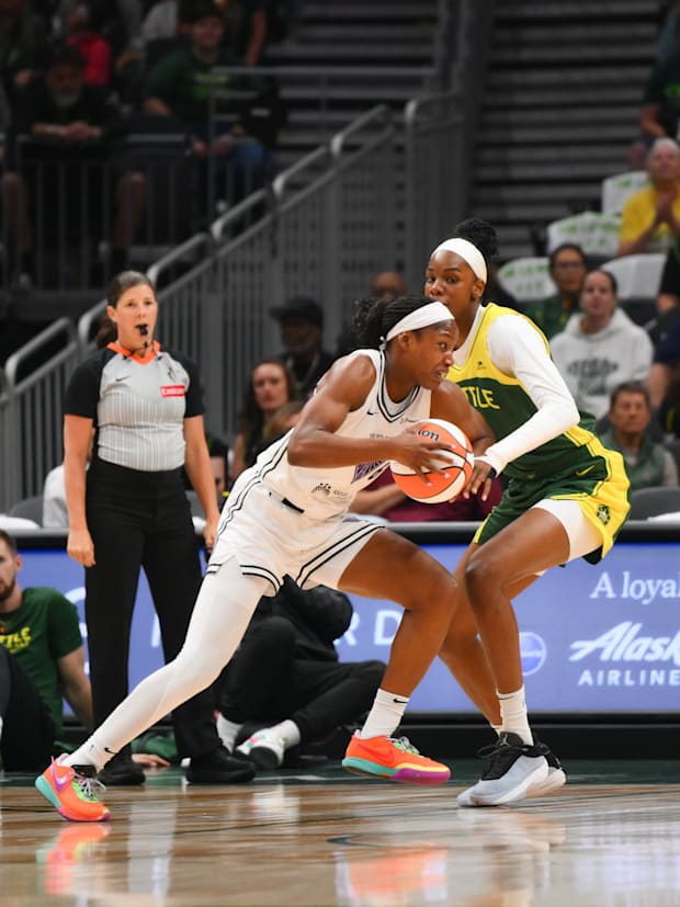 Golden State Valkyries guard Kaila Charles drives to the basket while guarded by Seattle Storm center Dominique Malonga. 