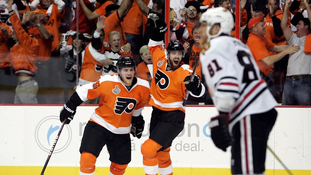 June 9, 2010; Philadelphia, PA, USA; Philadelphia Flyers left wing Ville Leino (center) and defenseman Matt Carle (left) celebrate a goal by left wing Scott Hartnell (not pictured) during the third period of game six of the 2010 Stanley Cup Finals as Chicago Blackhawks right wing Marian Hossa (81) skates away at the Wachovia Center. The Blackhawks won 4-3 to win the Stanley Cup.