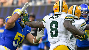 Oct 6, 2024; Inglewood, California, USA; Green Bay Packers running back Josh Jacobs (8) stiff arms Los Angeles Rams linebacker Troy Reeder (51) during the third quarter at SoFi Stadium. Mandatory Credit: Robert Hanashiro-Imagn Images