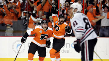June 9, 2010; Philadelphia, PA, USA; Philadelphia Flyers left wing Ville Leino (center) and defenseman Matt Carle (left) celebrate a goal by left wing Scott Hartnell (not pictured) during the third period of game six of the 2010 Stanley Cup Finals as Chicago Blackhawks right wing Marian Hossa (81) skates away at the Wachovia Center. The Blackhawks won 4-3 to win the Stanley Cup.