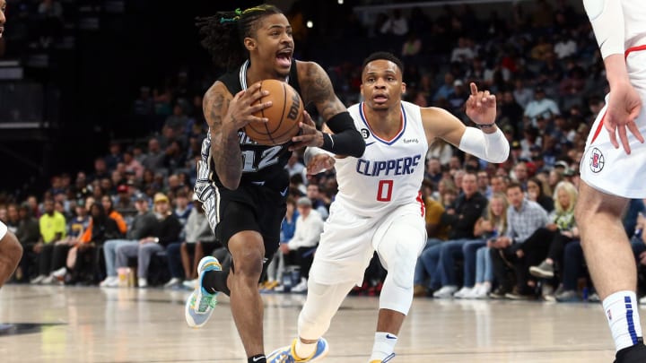 Mar 31, 2023; Memphis, Tennessee, USA; Memphis Grizzlies guard Ja Morant (12) moves to the basket as Los Angeles Clippers guard Russell Westbrook (0) defends during the first half at FedExForum. Mandatory Credit: Petre Thomas-USA TODAY Sports