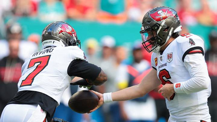Dec 28, 2025; Miami Gardens, Florida, USA; Tampa Bay Buccaneers quarterback Baker Mayfield (6) hands the ball off to running back Bucky Irving (7) during the first quarter at Hard Rock Stadium. Mandatory Credit: Sam Navarro-Imagn Images