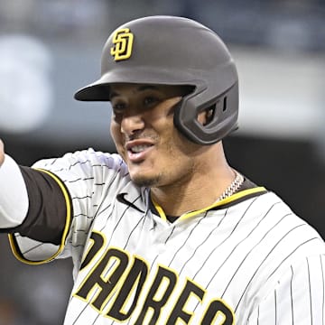 Manny Machado points to the dugout after his 2,000th career hit.