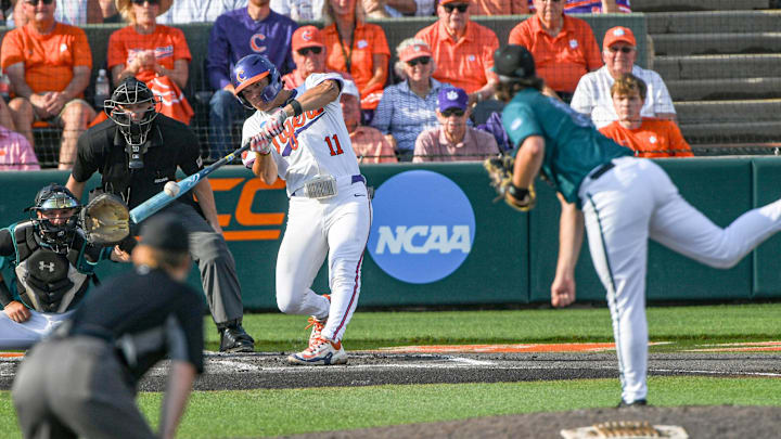 Jun 2, 2024; Clemson, South Carolina, USA; Clemson senior Jimmy Obertop (11) hits against Coastal Carolina senior Trevor Hinkel (19) during the bottom of the first inning of the NCAA baseball Clemson Regional at Doug Kingsmore Stadium in Clemson.