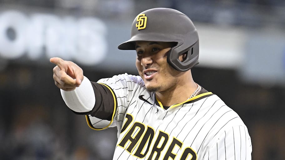 Manny Machado points to the dugout after his 2,000th career hit. | Denis Poroy-Imagn Images