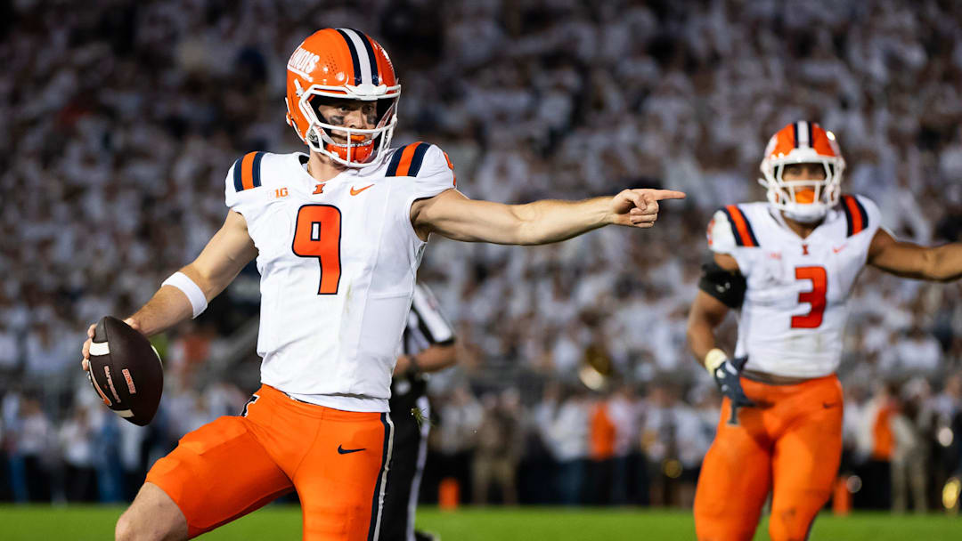 Illinois quarterback Luke Altmyer (9) points to one of his blockers as he runs with the ball in the second quarter of a Big Ten football game against Penn State, Saturday, Sept. 28, 2024, in State College, Pa.