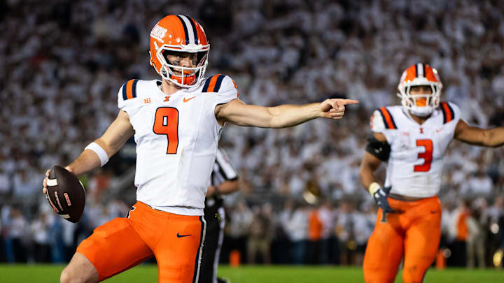 Illinois quarterback Luke Altmyer (9) points to one of his blockers as he runs with the ball in the second quarter of a Big Ten football game against Penn State, Saturday, Sept. 28, 2024, in State College, Pa.