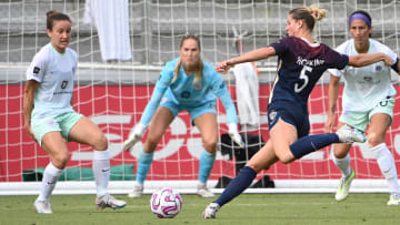 Sep 9, 2023; Cary, North Carolina, USA; North Carolina Courage forward Haley Hopkins (5) shoots as Racing Louisville FC defender Julia Lester (15) and goalkeeper Katie Lund (1) and defender Abby Erceg (20) defend in the second half at WakeMed Soccer Park. Mandatory Credit: Bob Donnan-USA TODAY Sports