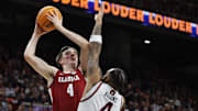 Mar 8, 2025; Auburn, Alabama, USA;  Alabama Crimson Tide forward Grant Nelson (4) takes a shot over Auburn Tigers forward Johni Broome (4) during the first half at Neville Arena.
