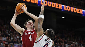 Mar 8, 2025; Auburn, Alabama, USA;  Alabama Crimson Tide forward Grant Nelson (4) takes a shot over Auburn Tigers forward Johni Broome (4) during the first half at Neville Arena.