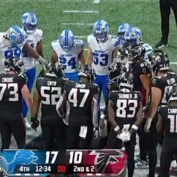 Lions and Falcons players held hands in a circle after Morice Norris was taken off the field in an ambulance.