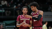 Jan 8, 2025; Coral Gables, Florida, USA; Florida State Seminoles guard Justin Thomas (25) talks to guard Daquan Davis (5) against the Miami Hurricanes during the first half at Watsco Center. Mandatory Credit: Sam Navarro-Imagn Images