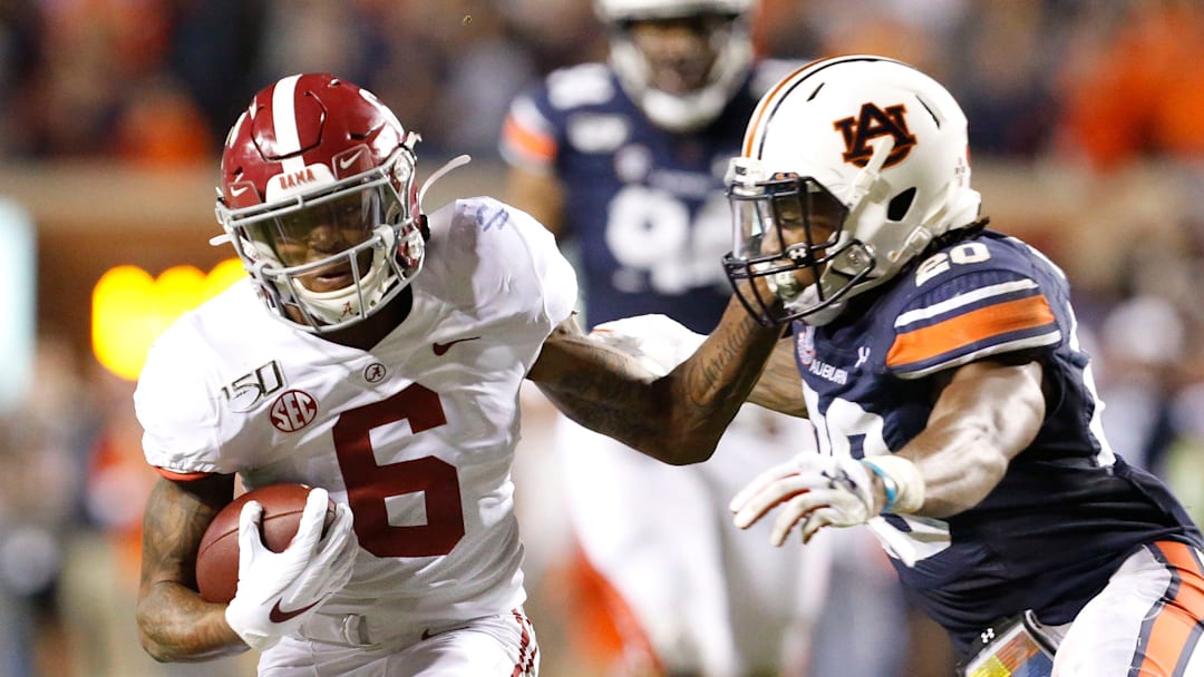 Alabama wide receiver DeVonta Smith (6) attempts to fend off a tackle by Auburn defensive back Jeremiah Dinson (20) during the Iron Bowl in Jordan-Hare Stadium on Nov. 30, 2019. Alabama wide receiver DeVonta Smith (6) attempts to fend off a tackle by Auburn defensive back Jeremiah Dinson (20) during the Iron Bowl in Jordan-Hare Stadium on Nov. 30, 2019.