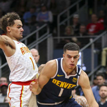 Jan 6, 2020; Atlanta, Georgia, USA; Denver Nuggets forward Michael Porter Jr. (1) drives on Atlanta Hawks guard Trae Young (11) in the first half at State Farm Arena. 