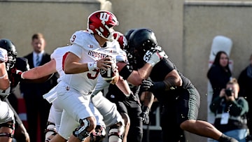 Nov 2, 2024; East Lansing, Michigan, USA;  Indiana Hoosiers quarterback Kurtis Rourke (9) rolls out looking for a receiver during the first quarter against the Michigan State Spartans at Spartan Stadium. Mandatory Credit: Dale Young-Imagn Images