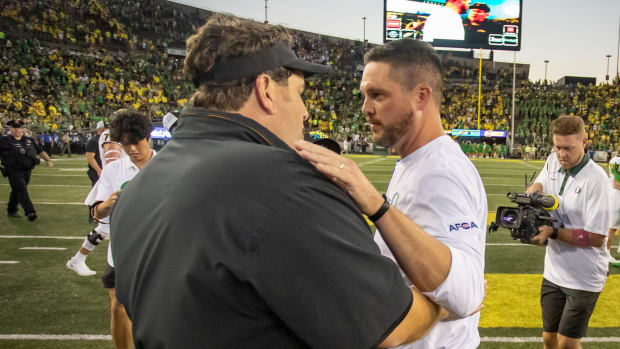 Oregon head coach Dan Lanning and Idaho head coach Jason Eck shake hands 