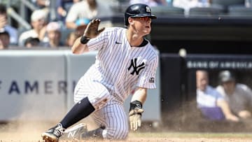 Aug 25, 2024; Bronx, New York, USA;  New York Yankees first baseman DJ LeMahieu (26) slides safely at home plate in the second inning against the Colorado Rockies at Yankee Stadium. Mandatory Credit: Wendell Cruz-Imagn Images