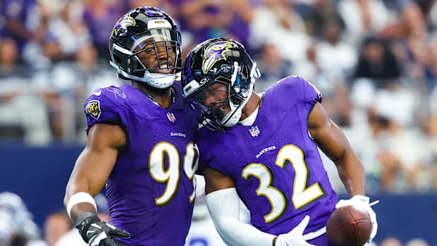 Baltimore Ravens safety Marcus Williams celebrates with linebacker Odafe Oweh.
