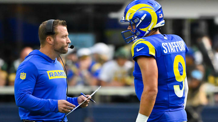 Oct 6, 2024; Inglewood, California, USA; Los Angeles Rams quarterback Matthew Stafford (9) talks to head coach Sean McVey during a timeout in the third quarter against the Green Bay Packers at SoFi Stadium. Mandatory Credit: Robert Hanashiro-Imagn Images