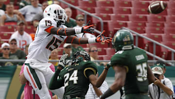 Sep 28, 2013; Tampa, FL, USA; South Florida Bulls defensive back Johnny Ward (24) defends Miami Hurricanes wide receiver D'Mauri Jones (15) during the second half at Raymond James Stadium. Miami Hurricanes defeated the South Florida Bulls 49-21. Mandatory Credit: Kim Klement-Imagn Images