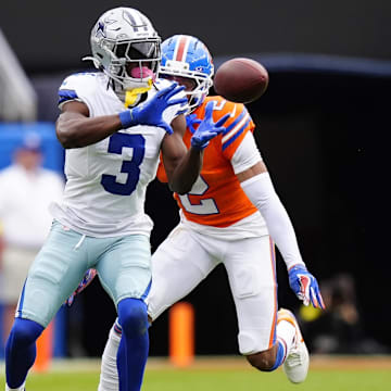 Dallas Cowboys wide receiver George Pickens makes a catch against Denver Broncos cornerback Pat Surtain II in the second quarter  at Empower Field at Mile High.