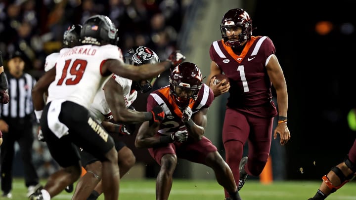 Nov 18, 2023; Blacksburg, Virginia, USA; Virginia Tech Hokies quarterback Kyron Drones (1) runs the ball against the North Carolina State Wolfpack at Lane Stadium. Mandatory Credit: Peter Casey-USA TODAY Sports